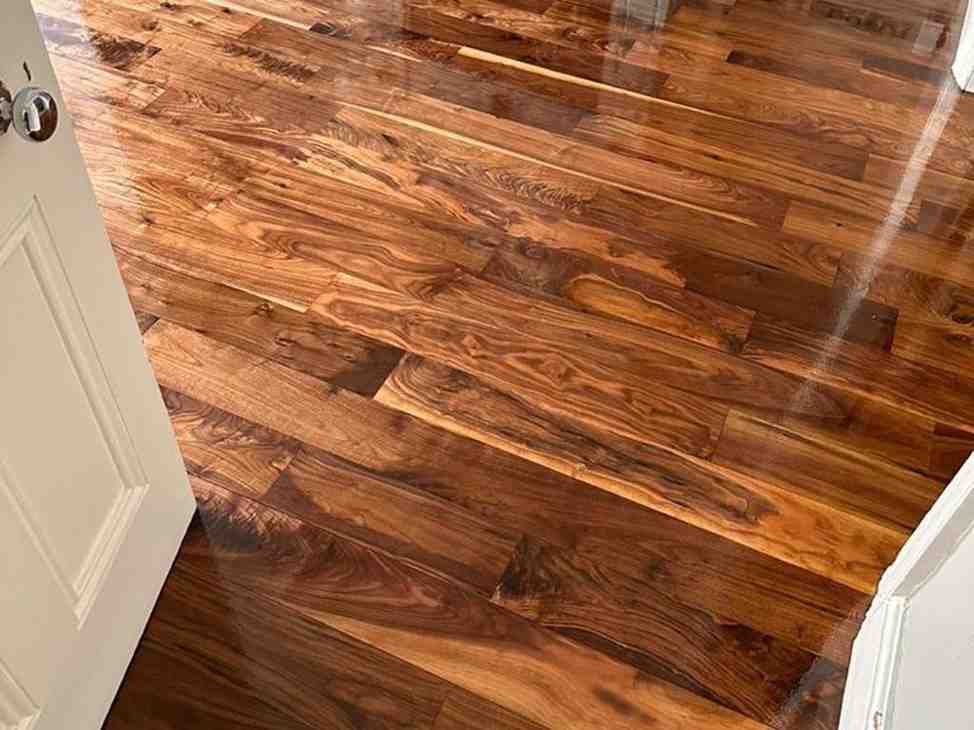 Real photograph of a restored walnut wooden floor in a Dublin home, professionally sanded and refinished by Artisan Flooring to reveal rich natural grain, deep colour variation, and a high-quality polished finish.